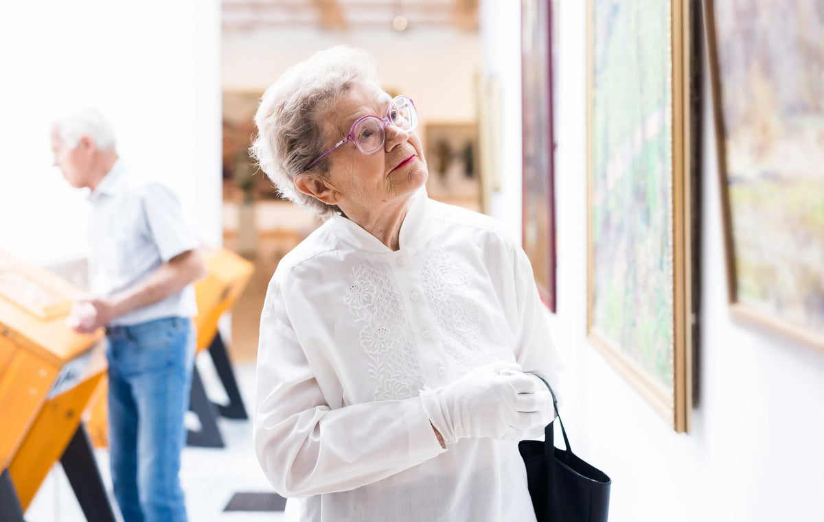 An art collector studying a painting in a gallery